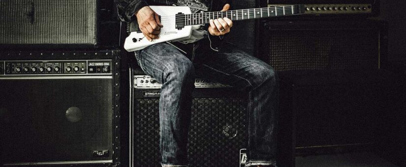 A wall of guitar amps used by a guitarist