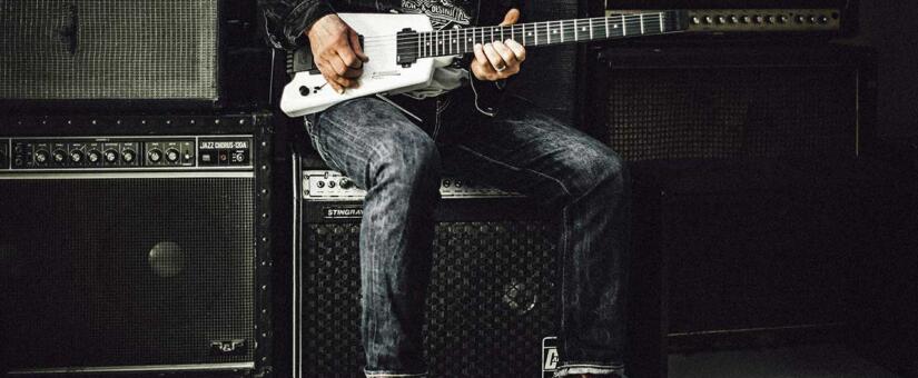A wall of guitar amps used by a guitarist